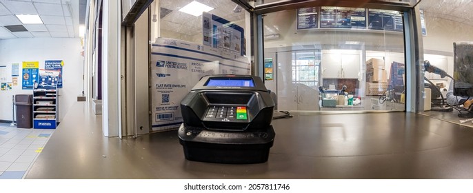 Window for packages with a credit card scanner, Very wide-angle, empty only a few customers in USPS post office in New York, the Bronx, 2100 White Plains Rd, 10462, United States of America, 10.13.202