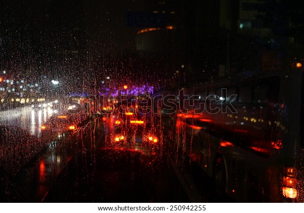 window rain blurred city\
lights