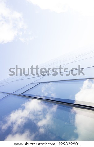 a window and reflected sky that continue into the background