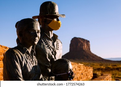 WINDOW ROCK, UTAH/USA - JULY 1 2020 : Two of three statues of the Native American family outside of Monument Valley wear face masks for COVID-19, the mother is unmasked, the park is closed. 