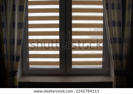 Window roller, duo system day and night.  colored fabric roller blinds on window. Roll curtains.