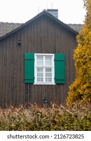 The window of a rustic house seen through the fence