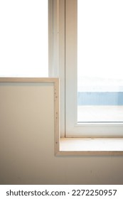 Window sill making a sharp angle by a door.