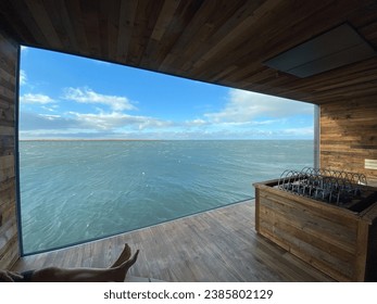 Window at Sky Lagoon sauna. Largest window in Iceland with views of Reykjavik Harbour.  - Shutterstock ID 2385802129