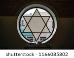 Window in synagogue in form of Star of David, six-pointed star with sunlight, Jewish symbol, toned