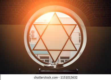 Window in synagogue in form of Star of David, six-pointed star with sunlight, Jewish symbol, toned