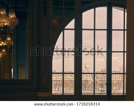 window through which you look at a Paris ferris wheel