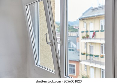 Window tilt open in a city apartment, letting in fresh air