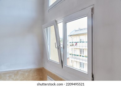 Window tilt open in a city apartment, letting in fresh air - Shutterstock ID 2209495521