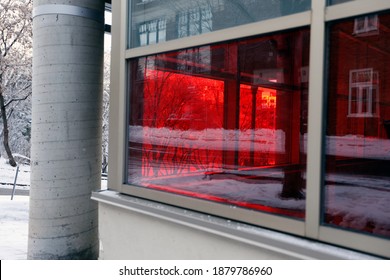 A Window Tinted In Red On A Building