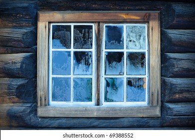 Window of a traditional Norwegian hut with frost patterns