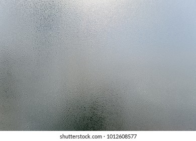 Window transparent blurred foggy glass with condensated water drops monochrome background. Vibrant freshness simplicity texture, season mood image