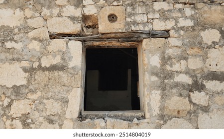 Window of a typical abandoned rustic house made of limestone rocks in the Eastern Mediterranean region in Turkey