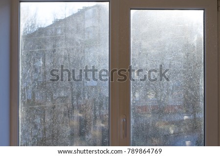 Window with very dirty and dusty glass in daylight