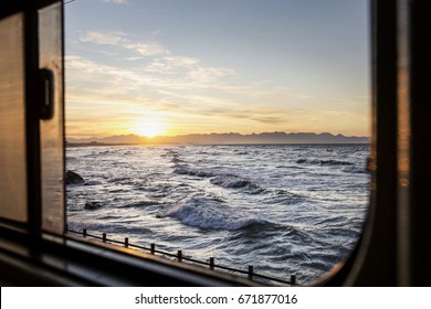 A Window View if the Ocean while Sitting in a Train. Ocean and Sea - Powered by Shutterstock