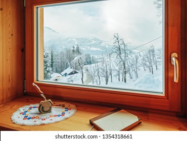 Window with view on Alpine mountains in snowy winter in Austria. Window and snowy Alps. Interior of contemporary living room of modern apartment house. Home and landscape. Deocr. Rustic, vintage style
