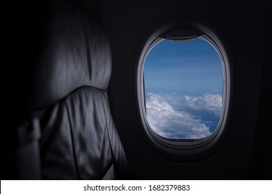 Window View From Passenger Seat On Commercial Airplane with blue sky, Concept of travel and air transportation.