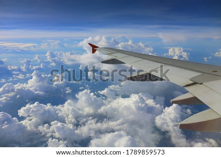 Window View From Passenger Seat On Commercial Airplane with blue sky, Concept of travel and air transportation.