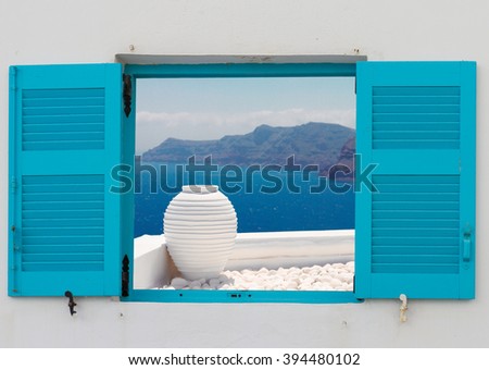 window with view of  white greek amfora against volcano caldera,  Santorini island, Greece