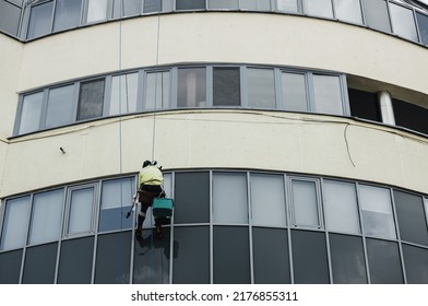 Window Washer Cleaning Building Facade. Work At Height. Industrial Mountaineering. High-rise Window Washing