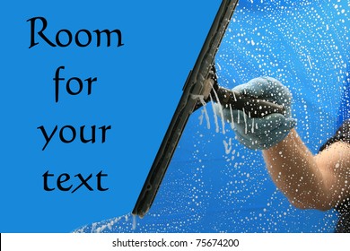 a window washer soaps and cleans a window with a squeegee with room for your text