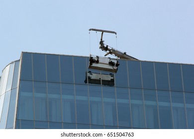 Window Washing Platform Suspended On Glass Facade Of A Skyscraper.