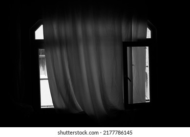 Window with white curtains. House in the dark, open window. selective focus. noise effect.
