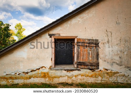 Window and wooden shutter at the side of an old building in Batsto village in the Pine Barrens of NewJersey, USA