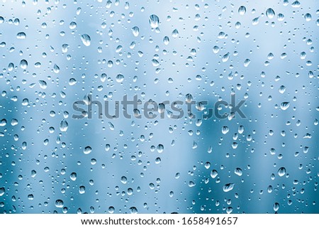 Rain​ drops​ on​ a​ Windows. Water​ rain​ drops​ on​ glass​ background.​ 