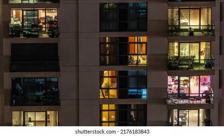 Windows of apartment building at night timelapse, the light from illuminated rooms of houses. Urban landscape of the glowing skyscrapers