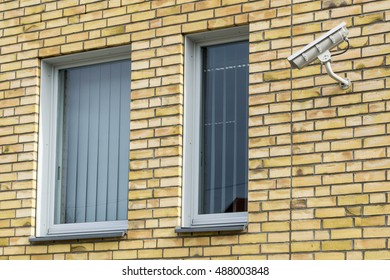 windows in a brick wall with security camera