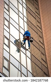 Windows cleaners are washing windows of the skyscraper in the downtown of St Petersburg.