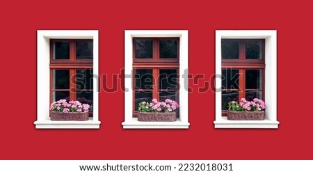 Windows with flower box. Italian architecture background. Vibrant color red wall facade. Small town house exterior. Street of European city building. Three window frames isolated on empty wall.