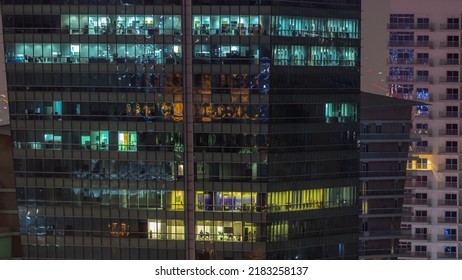 Windows Illuminated At Night In Modern Office Buildings Timelapse. Multi-level Skyscrapers With Many Glowing Lights.