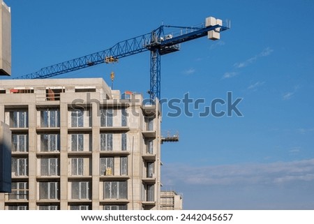 Windows installing Building work on the construction site in Europe. Modern Apartments Facade with windows. Not finished Architecture. growing building construction site
