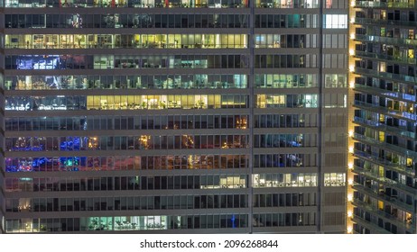 Windows Of Office Buildings During All Night Timelapse, The Lights Turning Off In The Windows Of Skyscrapers. Evening Landscape Of The City With Glowing Working Space