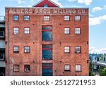 Windows in an old building relfect the area near the Foss Waterway in Tacoma, Washington.