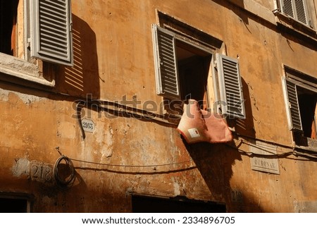 The windows on buildings in Italy vary from being extremely ornate to very mundane and they are used for many different reasons; a portal to let sunshine enter to means by which the laundry can dry.