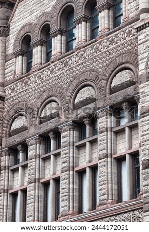 Windows on stone wall. Colonial architectural feature or detail in Old City Hall Building (1898), Toronto, Canada