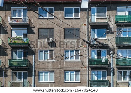 Windows in panel tower house, facade of building with balconies. Typical old socialist block of apartment in Bratislava city, Slovakia