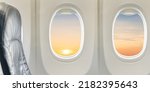 Windows and Seat Inside Plane flying on sunset sky in the morning flight Airplane well space for text presentation travel