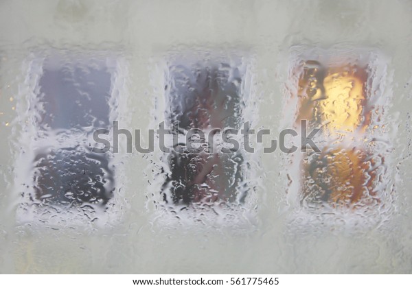 Windows seen through window in the rain.\
Rainy background.