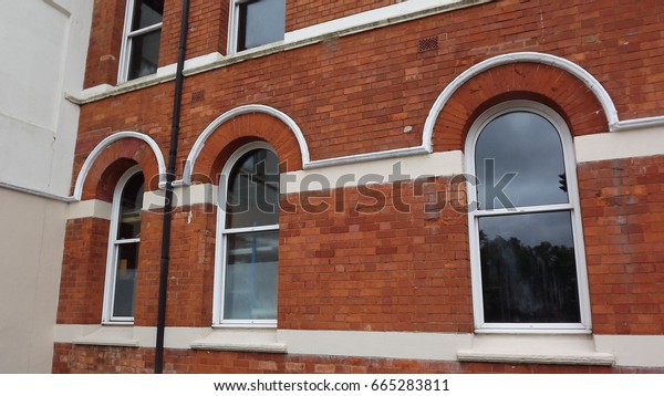 Windows from a\
Victorian factory. Crescent and round headed sash windows from a\
bicycle and car factory in\
England.