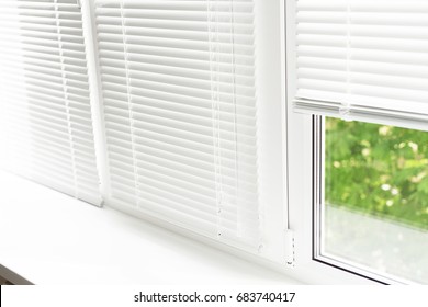 Windows With White Venetian Blinds.