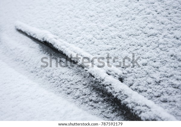windscreen wiper. car under\
snow.