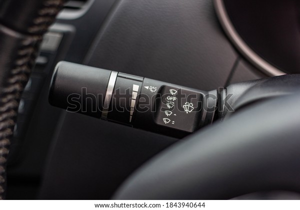 Windscreen wiper control switch in car. Wipers\
control. Modern car interior detail. adjusting speed of screen\
wipers in car.