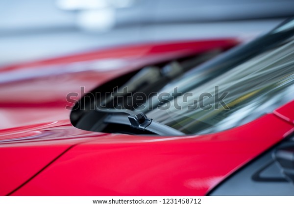 A windscreen wiper or windshield wiper is a\
device used to remove rain, snow, ice and debris from a windscreen\
or windshield On the red car