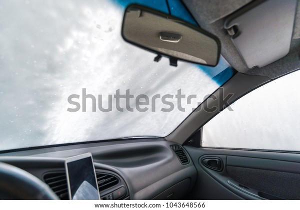 windshield of car in soap. car wash concept. view
from inside