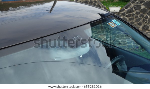 Windshield rain and light sensors\
position, luxury car windscreen, blue tinted glass, front view,\
technology design. Blue isolated glass  and dimming rear\
mirror