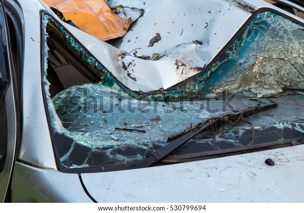 Windshield and roof are completely\
destroyed, damaged plying collision with another\
car.